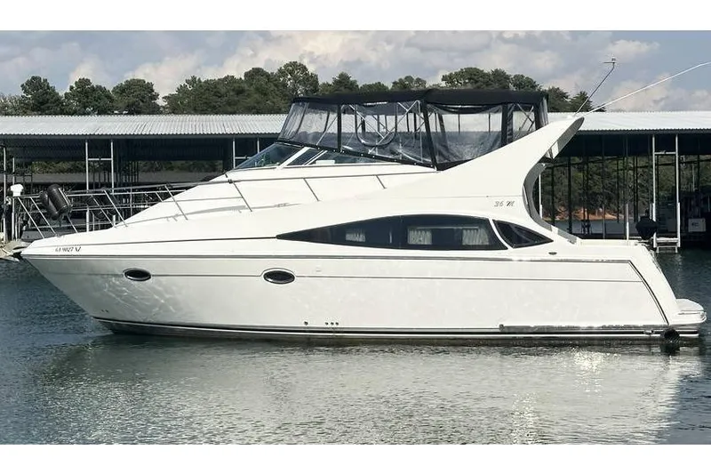  Yacht Photos Pics 2005 Carver 36 Mariner yacht docked on calm water, side view.