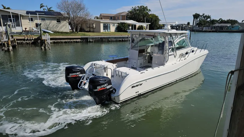 K Dee Yacht Photos Pics 2008 World Cat 320 EC boat with twin Suzuki outboard engines on a calm waterway.