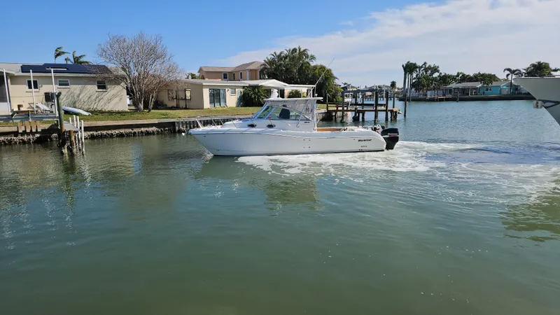 K Dee Yacht Photos Pics 2008 World Cat 320 EC cruising in a calm residential waterway.
