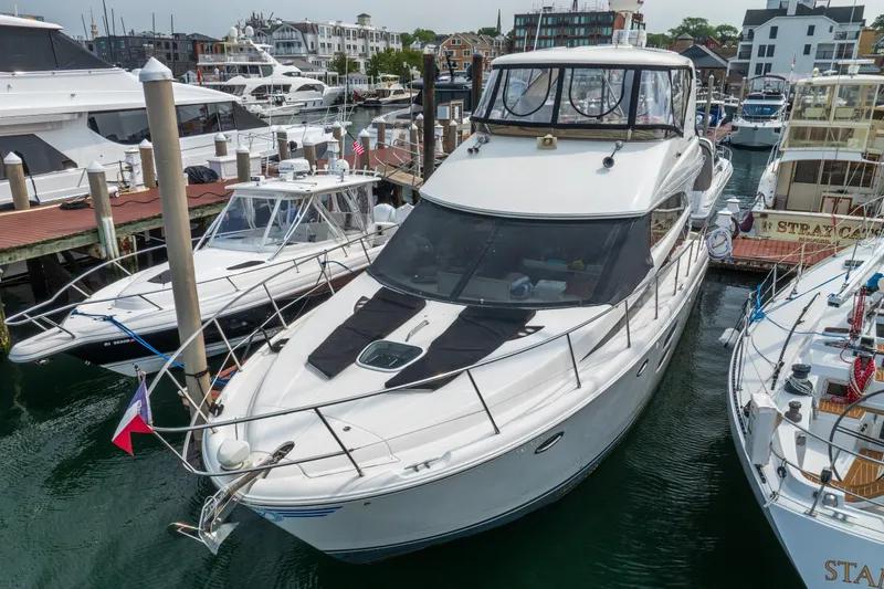  Yacht Photos Pics 2009 Meridian 441 Sedan yacht docked at a marina, surrounded by other boats.
