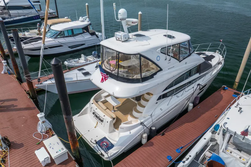  Yacht Photos Pics 2009 Meridian 441 Sedan yacht docked at marina, surrounded by other boats.