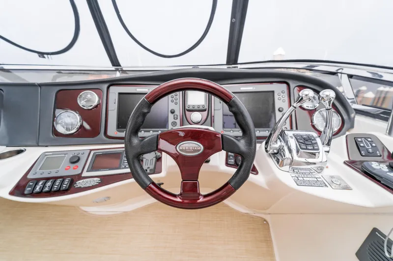  Yacht Photos Pics 2009 Meridian 441 Sedan helm with steering wheel, controls, and navigation instruments.