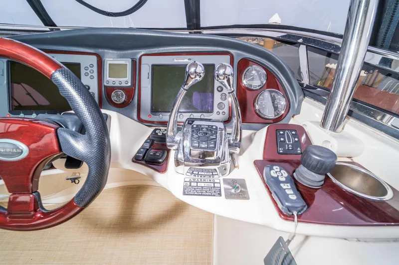  Yacht Photos Pics 2009 Meridian 441 Sedan helm with advanced navigation controls and polished wood accents.