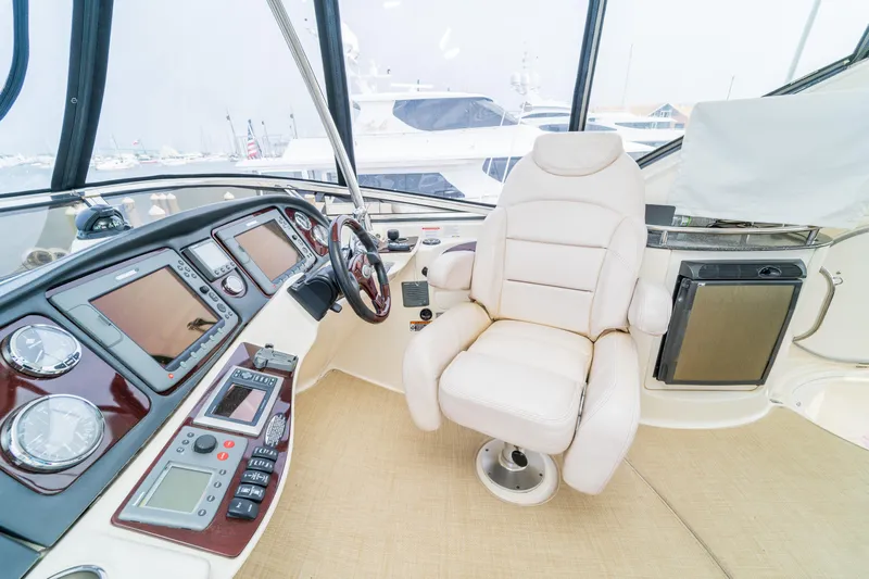  Yacht Photos Pics 2009 Meridian 441 Sedan helm with luxurious captain's chair and advanced navigation controls.