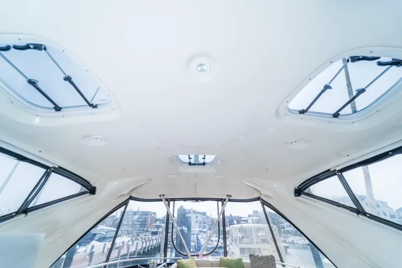  Yacht Photos Pics Interior view of 2009 Meridian 441 Sedan yacht with skylights and marina backdrop.