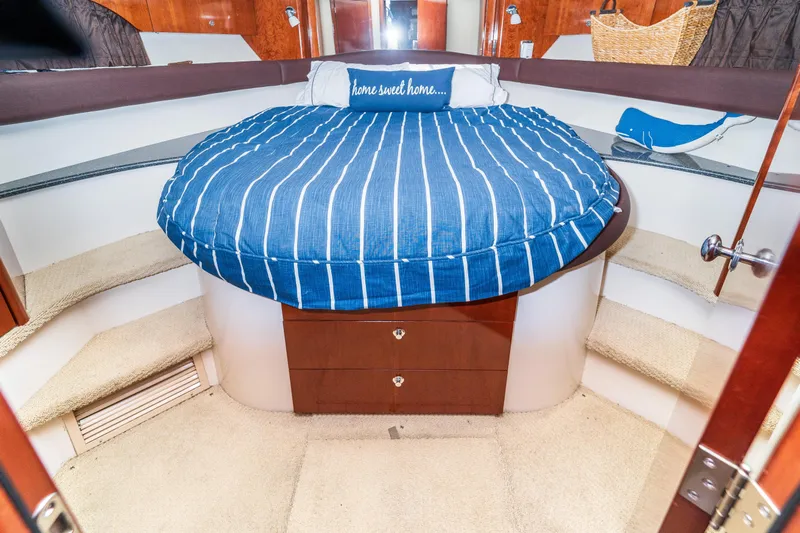  Yacht Photos Pics 2009 Meridian 441 Sedan interior with round bed, striped bedding, and cozy decor.