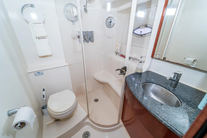 Yacht Photos Pics Luxurious bathroom in 2009 Meridian 441 Sedan yacht with shower, sink, and toilet.