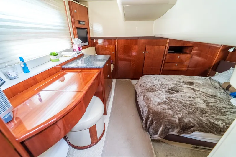  Yacht Photos Pics Luxurious interior of 2009 Meridian 441 Sedan yacht with wood cabinetry and cozy bed.