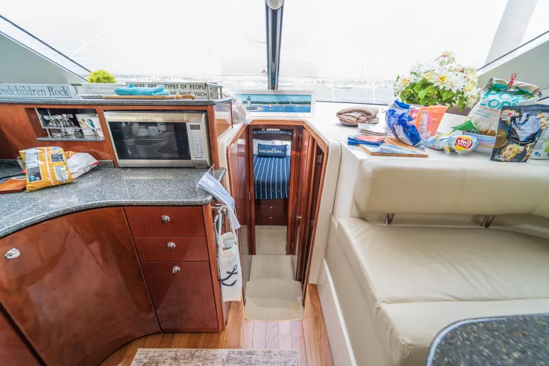  Yacht Photos Pics Interior of 2009 Meridian 441 Sedan yacht with kitchen and seating area.