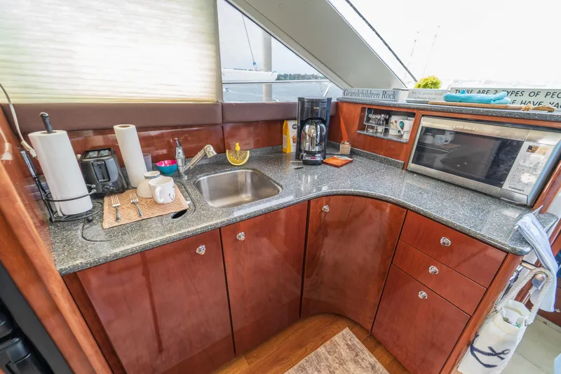  Yacht Photos Pics Luxurious 2009 Meridian 441 Sedan yacht kitchen with modern appliances and sleek countertops.