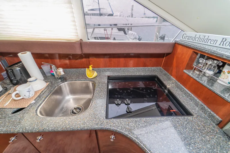  Yacht Photos Pics 2009 Meridian 441 Sedan yacht kitchen with sink, stove, and countertop accessories.