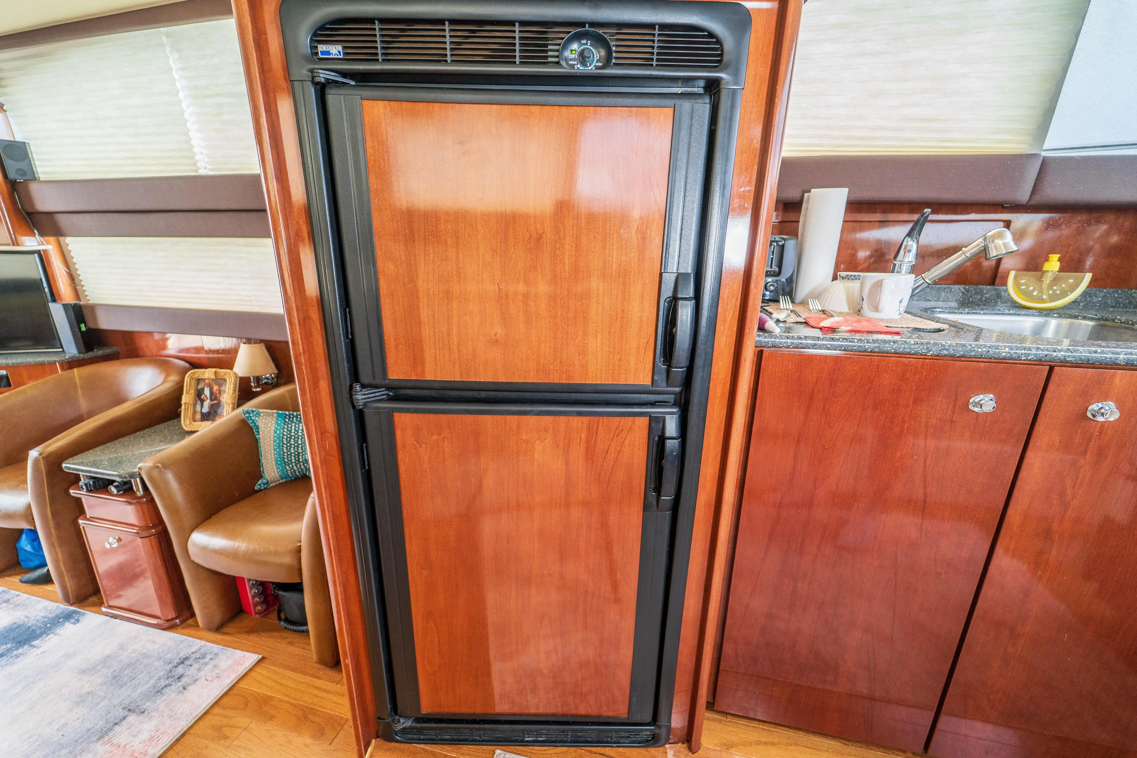  Yacht Photos Pics Wood-paneled refrigerator in 2009 Meridian 441 Sedan yacht interior.