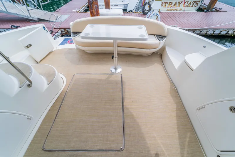  Yacht Photos Pics 2009 Meridian 441 Sedan yacht deck with seating and table, docked at marina.