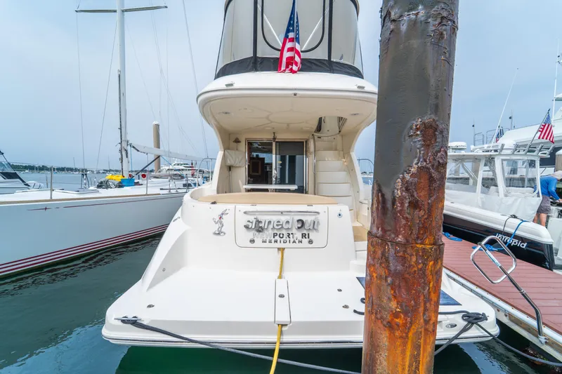 Yacht Photos Pics 2009 Meridian 441 Sedan yacht docked at marina with American flag.