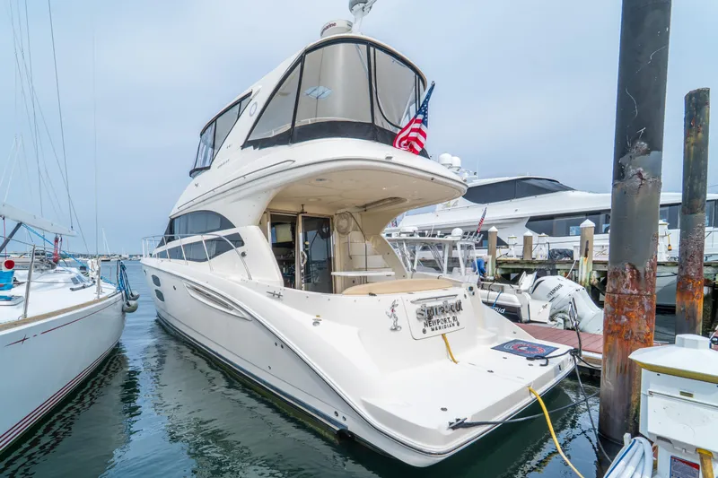  Yacht Photos Pics 2009 Meridian 441 Sedan yacht docked at marina, featuring sleek design and American flag.