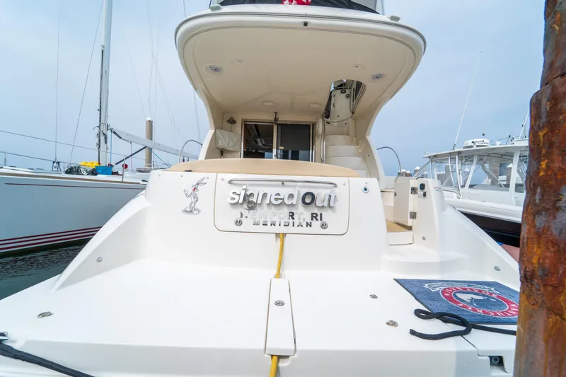  Yacht Photos Pics 2009 Meridian 441 Sedan yacht docked, rear view with nameplate and nautical decor.