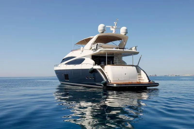  Yacht Photos Pics Luxury Princess Flybridge 85 Motor Yacht, 2010, on calm blue sea.