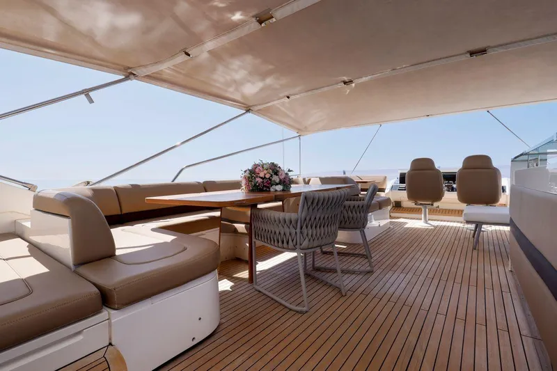  Yacht Photos Pics Luxurious 2010 Princess Flybridge 85 Motor Yacht deck with elegant seating and table arrangement.