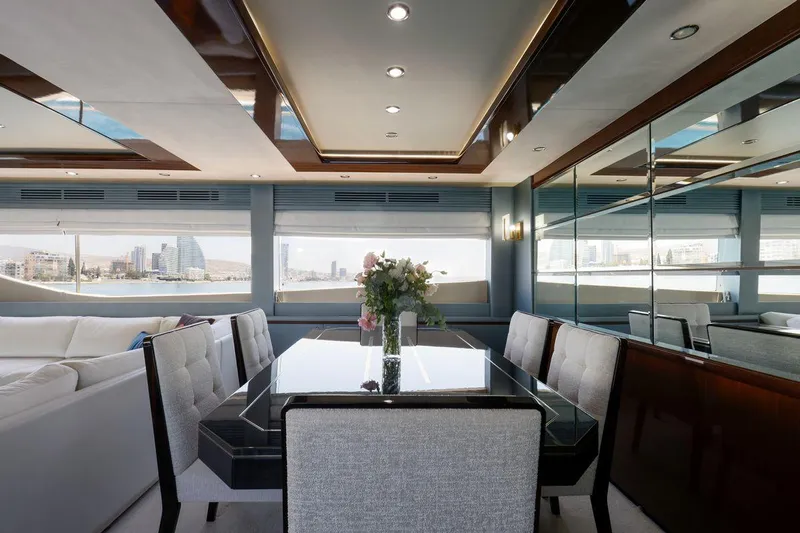  Yacht Photos Pics Luxurious dining area inside 2010 Princess Flybridge 85 Motor Yacht with elegant decor and city view.