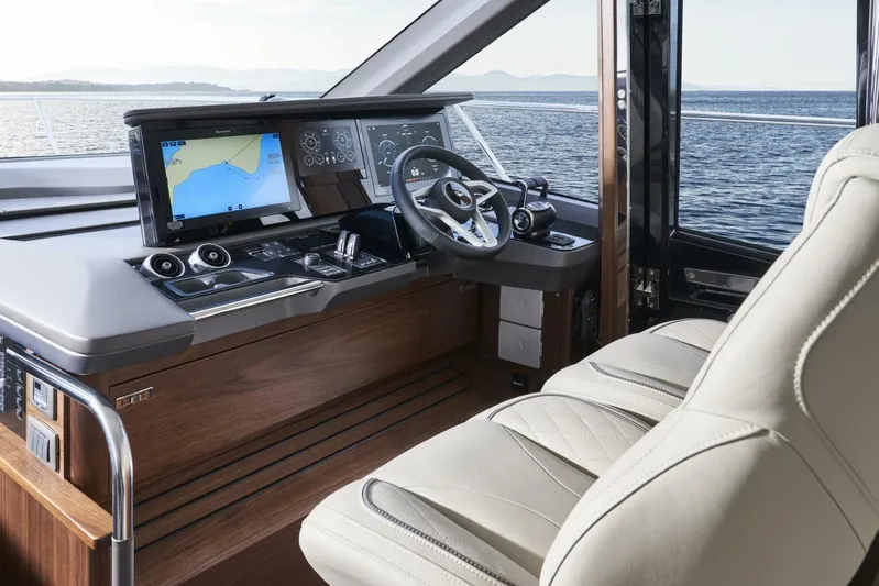  Yacht Photos Pics Luxurious 2026 Princess F65-079 yacht cockpit with advanced navigation system and plush seating.