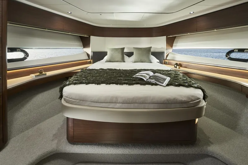  Yacht Photos Pics Luxurious cabin interior of 2026 Princess F65-079 yacht with elegant bedding and sea view.