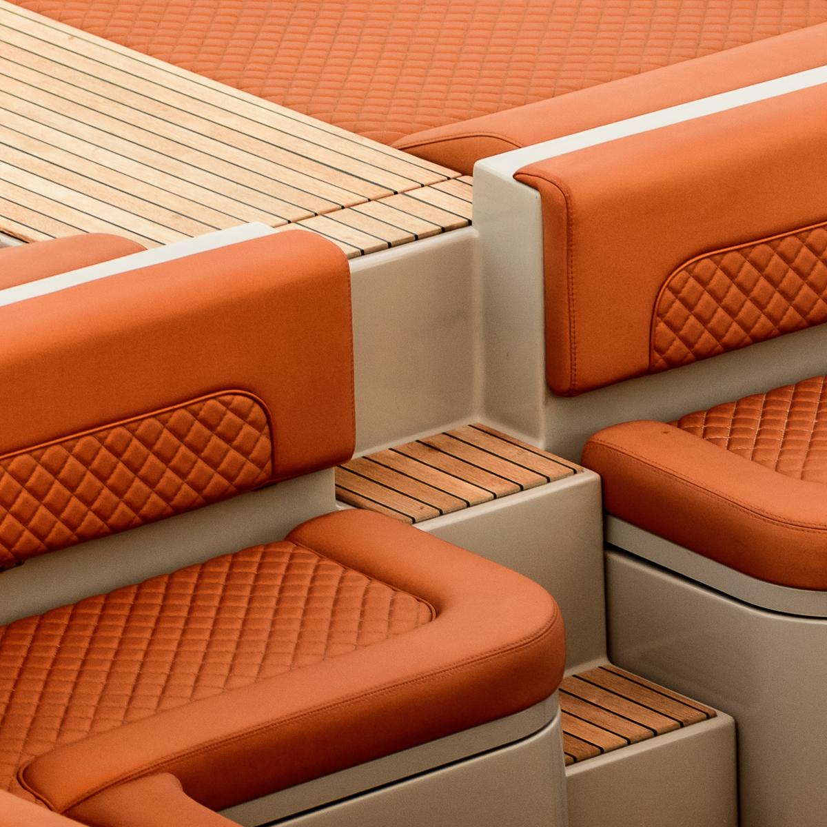 Luxurious orange seating on 2017 Skipper 120S Desire boat with wooden accents.
