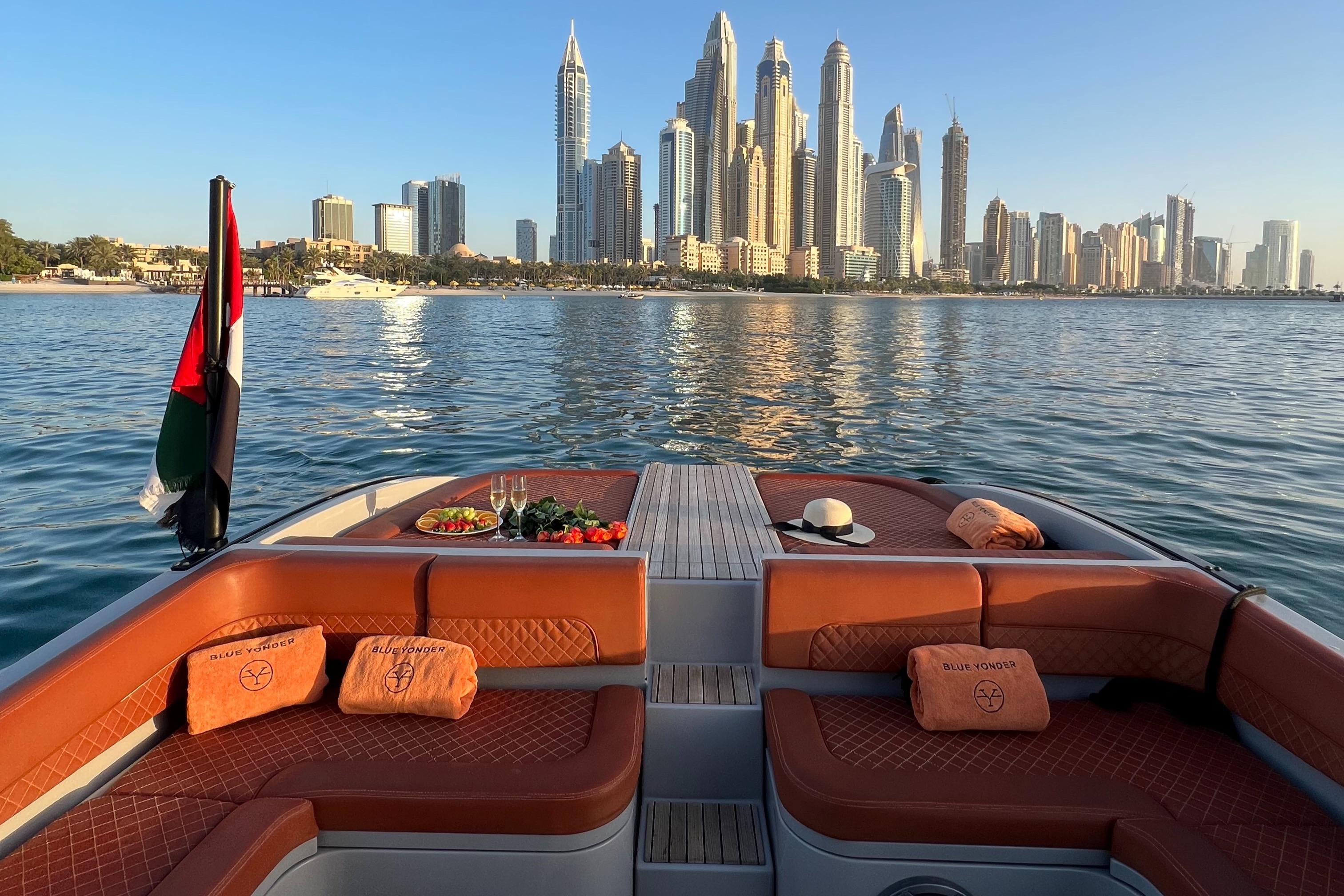 Luxurious Skipper 120S Desire yacht with Dubai skyline, 2017 model, elegant seating, and refreshments.