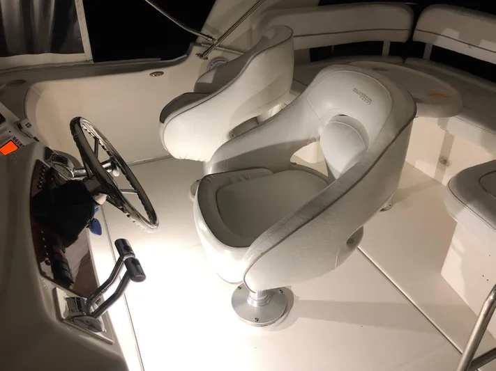 Yacht Photos Pics 2006 Silverton 34 Convertible boat interior with white captain's chairs and steering wheel.
