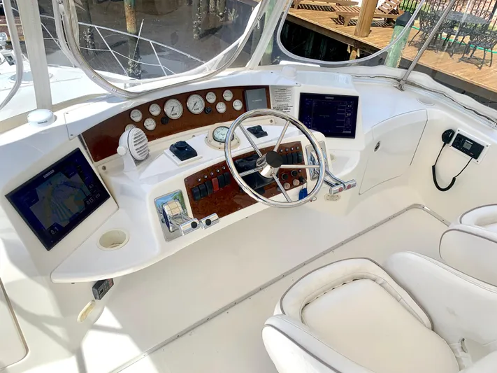  Yacht Photos Pics 2006 Silverton 34 Convertible helm with modern navigation equipment and white seating.