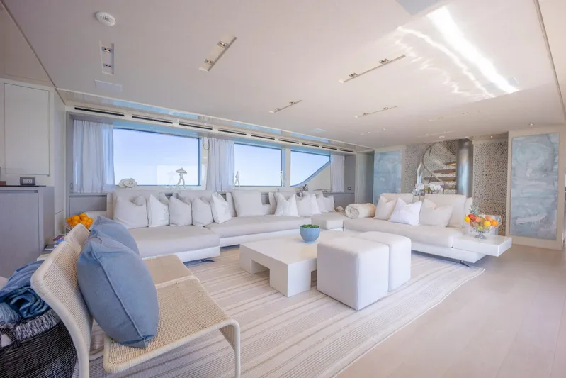 Phoenix Yacht Photos Pics Luxurious interior of 2019 Sanlorenzo SD112 yacht with modern white furnishings and large windows.