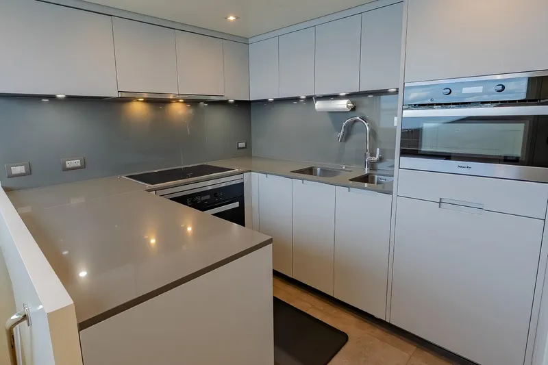 Phoenix Yacht Photos Pics Modern kitchen in 2019 Sanlorenzo SD112 yacht with sleek cabinetry and stainless steel appliances.