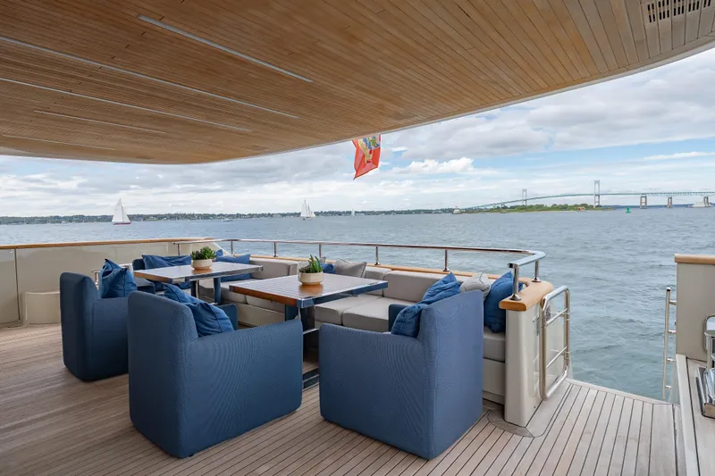 Phoenix Yacht Photos Pics Luxurious 2019 Sanlorenzo SD112 yacht deck with elegant seating, ocean view, and bridge in background.