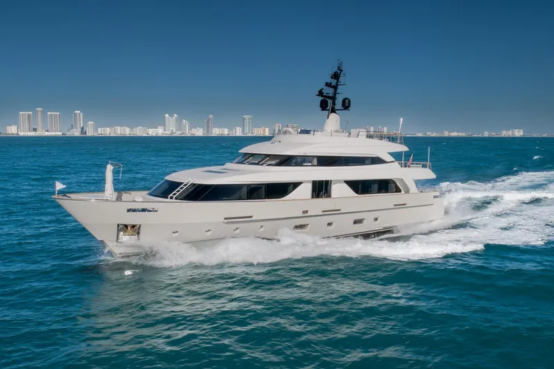Phoenix Yacht Photos Pics Luxurious 2019 Sanlorenzo SD112 yacht cruising on blue ocean near city skyline.