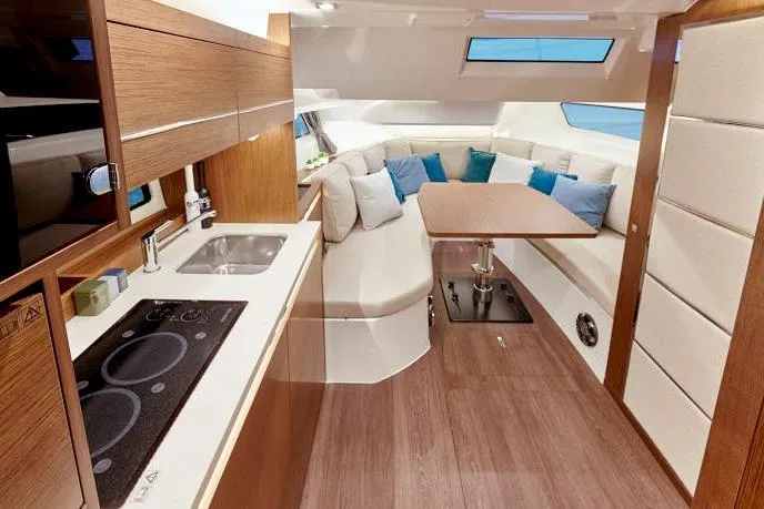  Yacht Photos Pics 2023 Jeanneau Leader 12.5 WA interior with modern kitchen and cozy seating area.
