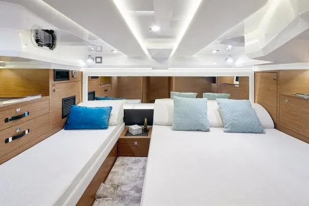  Yacht Photos Pics Luxurious interior of 2023 Jeanneau Leader 12.5 WA yacht with modern bedding and ambient lighting.