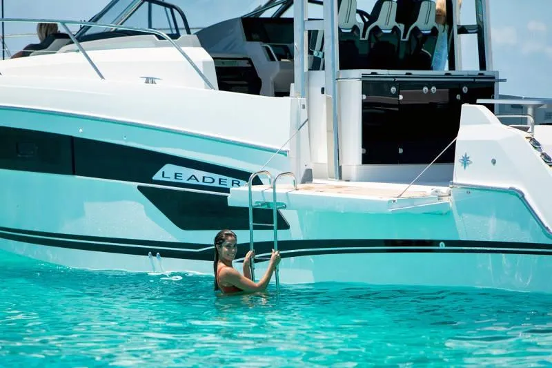  Yacht Photos Pics 2023 Jeanneau Leader 12.5 WA yacht with swimmer in turquoise water.