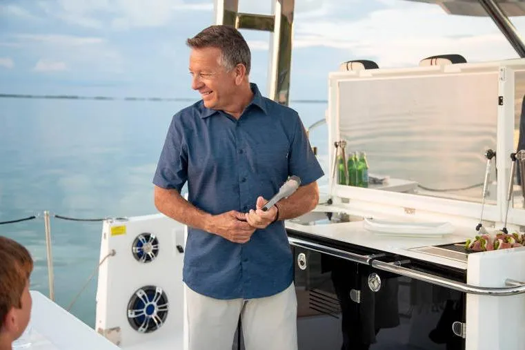  Yacht Photos Pics Man enjoying a barbecue on a 2023 Jeanneau Leader 12.5 WA boat.