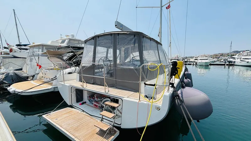  Yacht Photos Pics 2024 Beneteau Oceanis Yacht 54 docked in a marina, showcasing its elegant design.