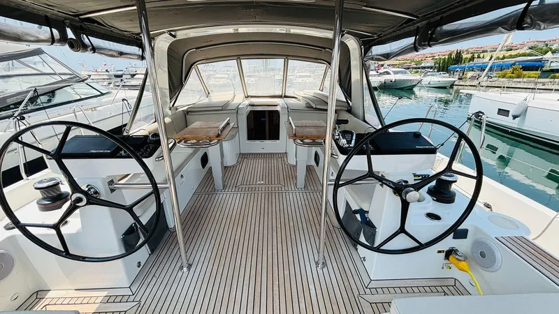  Yacht Photos Pics 2024 Beneteau Oceanis Yacht 54 cockpit with dual steering wheels and teak flooring.