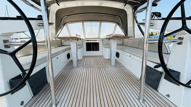  Yacht Photos Pics 2024 Beneteau Oceanis Yacht 54 cockpit with dual steering wheels and sleek seating.