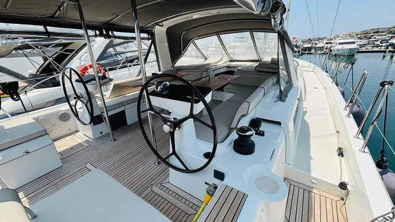  Yacht Photos Pics 2024 Beneteau Oceanis Yacht 54 cockpit with dual steering wheels and spacious seating.