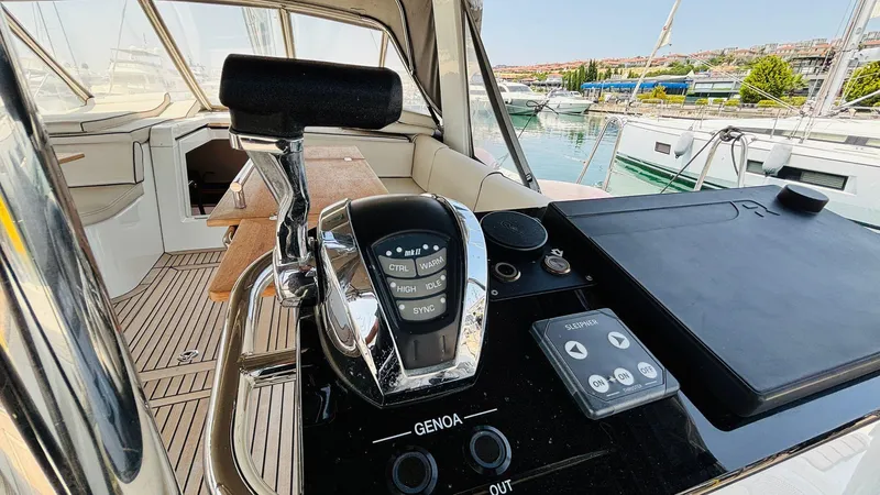  Yacht Photos Pics 2024 Beneteau Oceanis Yacht 54 cockpit with control panel and marina view.