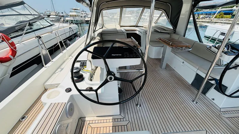  Yacht Photos Pics 2024 Beneteau Oceanis Yacht 54 cockpit with dual steering wheels and teak flooring.