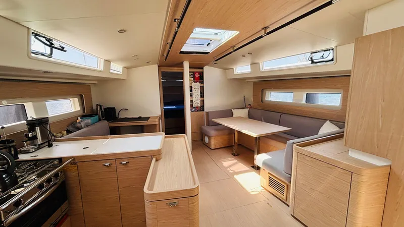  Yacht Photos Pics Luxurious interior of 2024 Beneteau Oceanis Yacht 54 with modern kitchen and dining area.