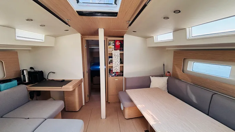  Yacht Photos Pics Luxurious interior of 2024 Beneteau Oceanis Yacht 54, featuring modern seating and dining area.