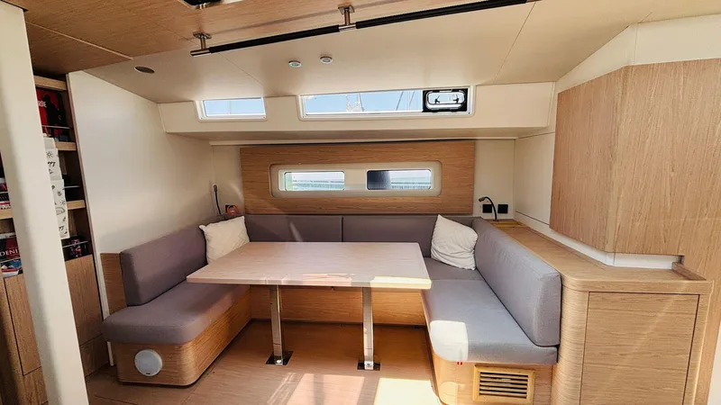  Yacht Photos Pics 2024 Beneteau Oceanis Yacht 54 interior with modern seating and dining area.