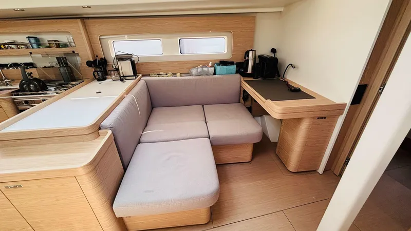  Yacht Photos Pics Modern interior of 2024 Beneteau Oceanis Yacht 54 with cozy seating and sleek design.