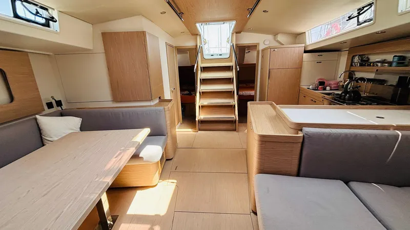  Yacht Photos Pics 2024 Beneteau Oceanis Yacht 54 interior with modern kitchen and seating area.