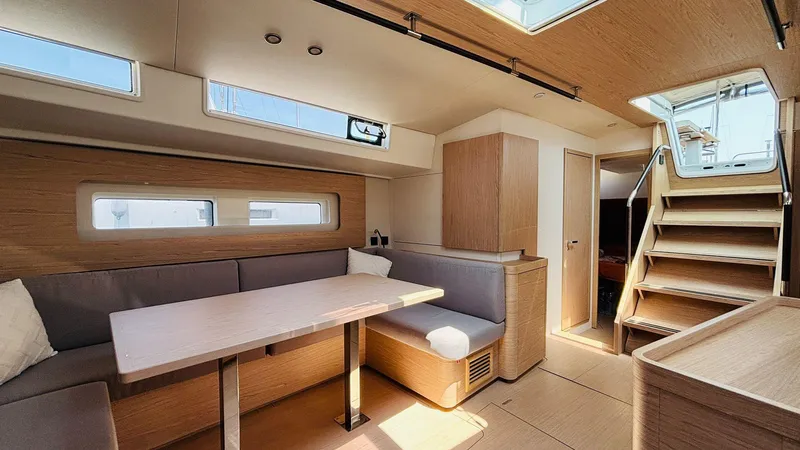  Yacht Photos Pics Luxurious interior of 2024 Beneteau Oceanis Yacht 54 with modern seating and natural light.