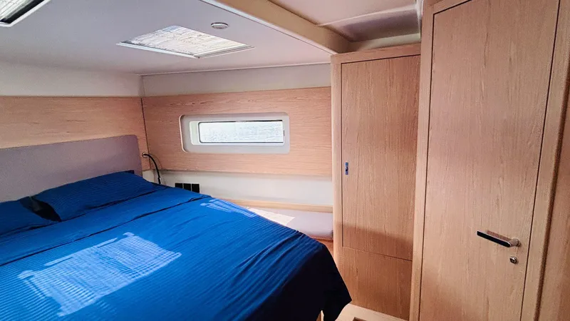  Yacht Photos Pics Luxurious cabin interior of 2024 Beneteau Oceanis Yacht 54 with modern wood finish.